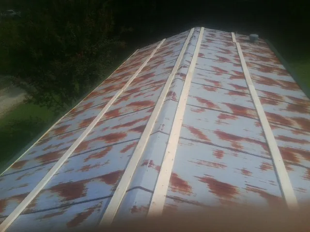 Rusted metal roof panels with new wood purlins before replacement — Storm Damage Roof Repair in Admire by Roofing Brothers